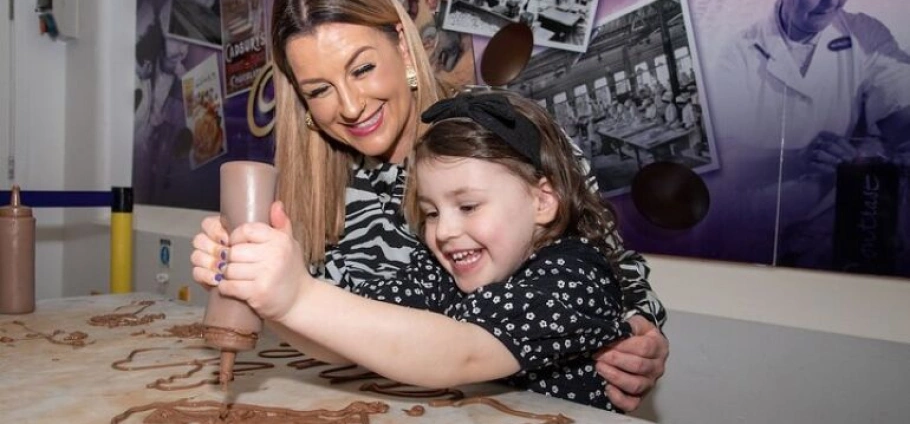 Mother and daughter enjoying chocolate crafting activity together at Cadbury World Birmingham