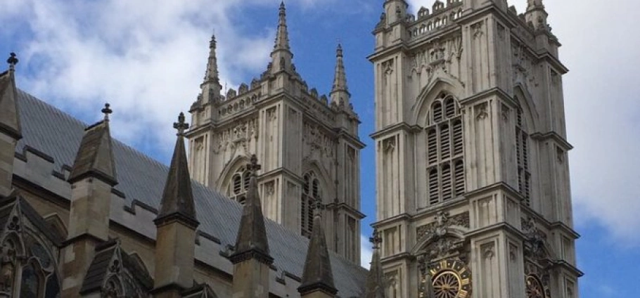 Westminster Abbey and Tower of London Tour | Westminster Abbey towers against a blue sky.