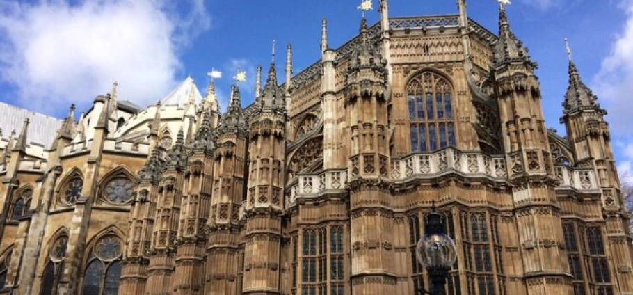 Westminster Abbey and Tower of London Tour | Gothic architecture of Westminster Abbey in London against a blue sky