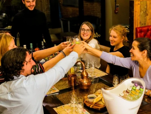 Group of friends toasting drinks at a restaurant table