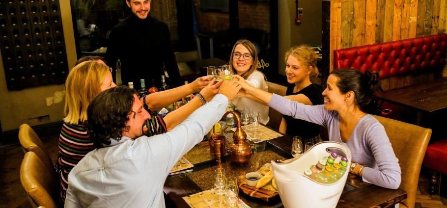 Group of friends toasting drinks at a restaurant table