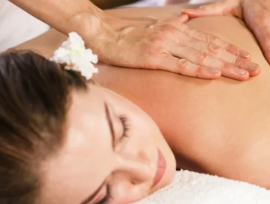 Woman receiving a relaxing back massage at Birmingham PURE Spa