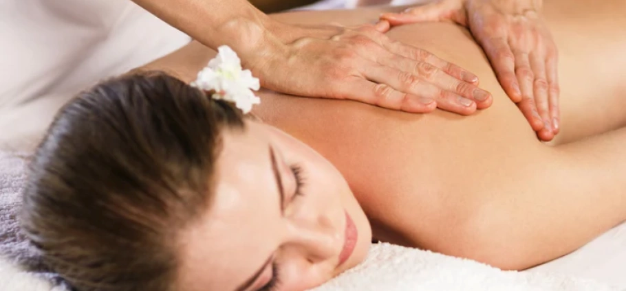 Woman receiving a relaxing back massage at Birmingham PURE Spa