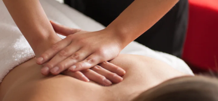 Person receiving a relaxing back massage therapy session at Birmingham PURE Spa