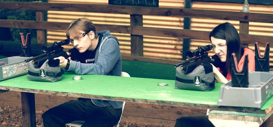 Two people aiming rifles at Rifle Shooting Experience Birmingham.